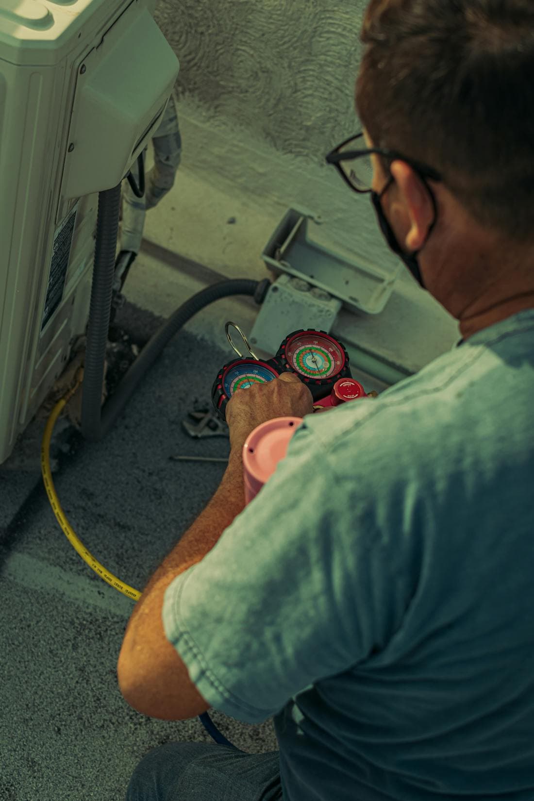 An HVAC technician servicing an AC unit